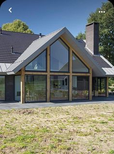 a large house sitting on top of a lush green field