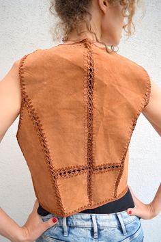 "Brown leather vest, vintage leather waist coat, sleeveless leather jacket, with lace, boho, crocheted, festival jacket, 80s style, XS/S Brown vintage leather vest with beautiful details. Crochet lace detailing in front and on the back. Looks very good and romantic! Size: seems like men's (XS) and women's (S) Measurements: Length: 50 cm/ 20\" Shoulder to shoulder: 36 cm/ 14\" Chest: 90 cm/ 35\" Condition: excellent Fabric: leather, cotton * Dry clean Model wears: UK 8/ EU 36/ US 4 Model's height Crochet Leather Jacket, Fall Leather Sleeveless Jacket, Sleeveless Festival Outerwear, Fitted Leather Jacket For Festival, Bohemian Fitted Leather Jacket For Fall, Fitted Sleeveless Outerwear For Festival, Leather Sleeveless Vest For Festivals, Fitted Leather Jacket For Winter Festival, Fitted Leather Festival Vest