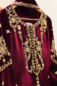 A heavily embellished beautiful three piece on pure burgundy velvet, adorned with the most stunning hand/ada work of dabka, naqshi, sequins and crystals done by our skilled artisans. Paired with a matching pure velvet shawl and flappers featuring intricate hand details. The length of the long Kameez is 48 inches. Agha Zardozi Embroidery On Velvet, Shawl With Formal Dress, Velvet Embroidery Suits, Dabka Work Embroidery, Velvet Pakistani Dress, Heavy Suits, Dabka Embroidery, Long Kameez, Casual Bridal Dress