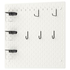 a white peg board with three hooks on it