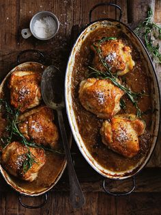 two pans filled with chicken covered in gravy and garnished with herbs