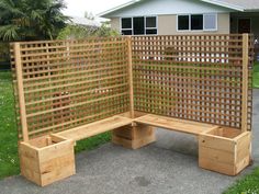 a wooden bench sitting on top of a sidewalk next to a green grass covered yard