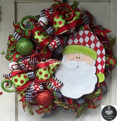 a christmas wreath with santa claus on it