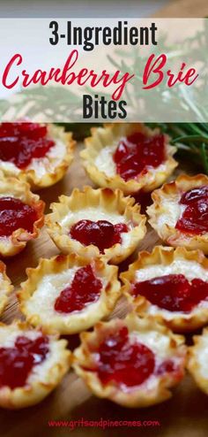 small cranberry brie bites on a cutting board with pine branches in the background