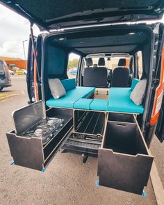 the back end of a van with its doors open and seats folded down in place