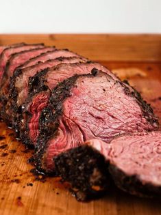 sliced steak on wooden cutting board ready to eat