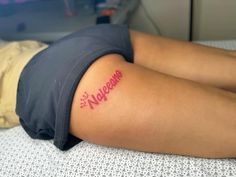 a woman laying on top of a bed with her arm wrapped around the side of her body