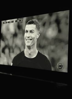 a black and white photo of a man on a television screen with the image of ronald ronald