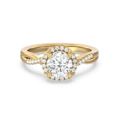 a yellow gold engagement ring with an oval cut diamond in the center