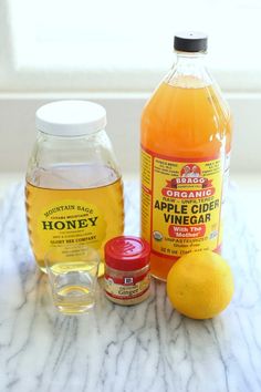 the ingredients to make an apple cider vinegar recipe are displayed on a marble countertop