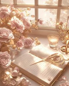 an open book sitting on top of a table next to flowers