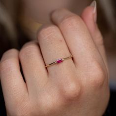 A July birthstone ring with a natural baguette ruby in 14K solid gold. A minimalist ring for women, ideal to be stackable with more dainty rings. A great Christmas gift for her. 100% handcrafted with love! * Material: 14K solid white gold, 14K yellow gold * Gemstone: Ruby, natural gemstone * Ruby's Weight: 0.12 ct * Ruby's Dimensions 4 mm x 2 mm HOW TO ORDER - CUSTOM ORDERS * Choose from the drop-down menus the available options (Ring size, Metal) and leave us a note for any special requirements. * For special orders (if you wish the ring to match an existing engagement ring) forward us pictures of the ring on a ruler from the front, side and top to mark the measurements, so we can adjust the design to fit properly to your engagement ring. PRODUCTION TIME - SHIPPING POLICIES * Please keep Simple Gold Rings For Women, Emerald Cut 14k Gold Ruby Promise Ring, Minimalist Emerald Cut Birthstone Ring, Minimalist Gold Ruby Ring, Minimalist Yellow Gold Ring With Ruby, Minimalist 14k Gold Emerald-cut Birthstone Ring, Minimalist 14k Gold Emerald Cut Birthstone Ring, Minimalist Ruby Ring With Birthstone, Minimalist 14k Gold Ruby Promise Ring