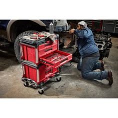 a man working on a red tool box