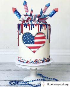 a patriotic cake with stars, stripes and hearts painted on the frosting is ready to be eaten