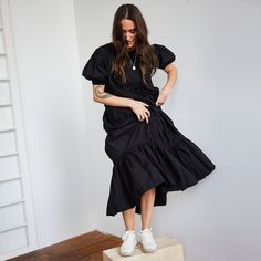 Thoughtfully crafted from ethically-sourced handwoven cotton and defined by its movement-enhancing tiered ruffles, this Short Sleeved Tiered Midi Dress is a timelessly elegant piece that will enliven your wardrobe. Effortless and flouncy, this ruffle dress falls midi length with arm coverage as well. Sizing: This collection emulates Japanese styling where fit is more generous and comfortable. Please specify size when ordering. S (US size 2-4) M (US size 6-8) L (US size 10-12) XL (US size 14-16) Fitted Tiered Cotton Ruffle Dress, Chic Cotton Tiered Dress With Ruffle Hem, Fitted Cotton Tiered Midi Dress, Fitted Tiered Cotton Midi Dress, Cotton Tiered Dress With Ruffles, Elegant Tiered Cotton Midi Dress, Cotton Tiered Midi Dress With Ruffle Hem, Cotton Tiered Dress With Ruffle Hem, Fitted Cotton Tiered Dress With Ruffle Hem