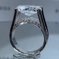 a fancy ring with an oval cut diamond in the center