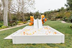 an inflatable pool with orange and white balloons