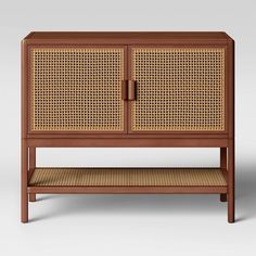 the sideboard is made out of wood and has wicker panels on one side