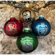 four christmas ornaments sitting on top of a marble counter