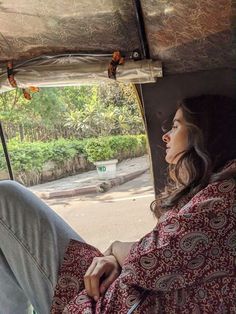 a woman sitting in the passenger seat of a vehicle