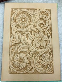 an intricately carved paper with flowers on it