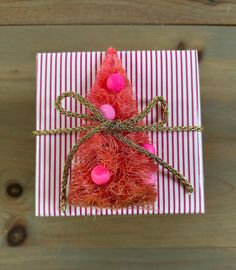 a gift wrapped in red and pink paper