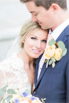 a bride and groom pose for a wedding photo