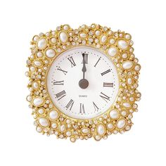 a gold and white clock with pearls on it's face is shown against a white background