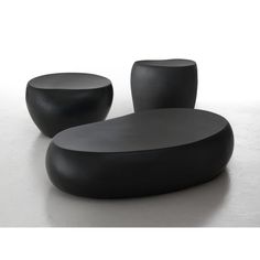 two black tables sitting on top of a white floor