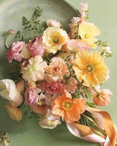 a bouquet of flowers sitting on top of a green plate