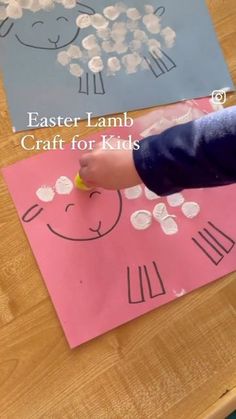 a child's hand is drawing sheep on paper