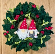 a crocheted wreath with two gnomes on it