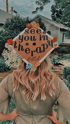 a woman wearing a graduation cap with the words see you in therapy written on it