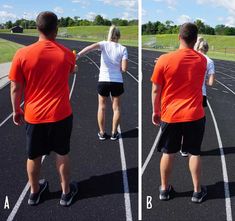 two people standing on a track with their arms around each other's shoulders, facing opposite directions