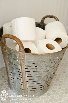 several rolls of toilet paper in a metal basket