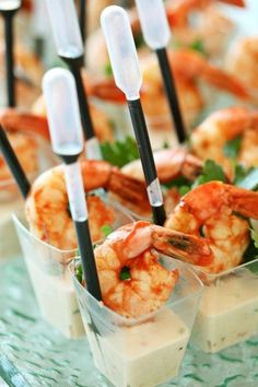 small cups filled with shrimp and dipping sauce