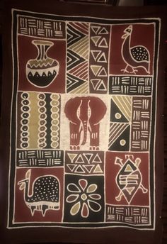 an elephant and giraffe design on a red, black, yellow and white blanket