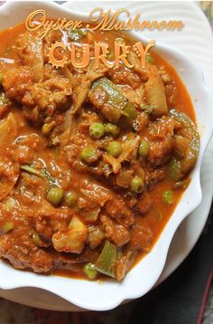 a white bowl filled with curry and vegetables