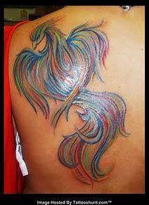 the back of a woman's shoulder with an image of a colorful fish on it