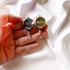 two personalized cuff rings are shown in the palm of someone's hand