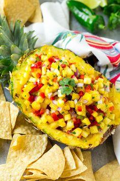 a pineapple with salsa and tortilla chips