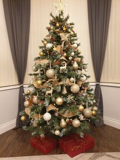 a decorated christmas tree with gold and silver ornaments