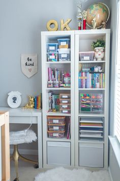 a white bookcase filled with lots of books