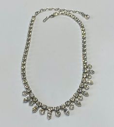 Beautiful silver tone and clear stone choker, perfect for a wedding, graduation or debutant.  This is a perfect accessory for that exciting night out.  This necklace is new new and has little to no signs of wear. Measurements:  42cm in total length, including the extender.  Square crystals are 0.5cm long and 0.5cm wide.  The round crystals are 0.5cm in diameter and the teardrop crystals are 1cm long and 0.5cm wide. Condition:  Excellent vintage condition.  No scratches, dents, or imperfections. Classic Silver Crystal Rhinestone Necklace, Classic Silver Rhinestone Necklace For Wedding, Glamorous Silver Rhinestone Necklace For Anniversary, Classic Silver Rhinestone Necklace, Sparkling Crystal Rhinestone Necklace For Anniversary, Adjustable Silver Sparkling Rhinestone Necklace, Adjustable Rhinestone Necklaces For Wedding, Classic Silver Wedding Choker, Classic Silver Choker For Wedding