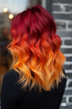 Mid-back length hair with a fiery red and orange ombre is a 2024 trend. This vibrant and dynamic color transition brings energy and flair, perfect for a bold and lively appearance. Fire Hair Color, Orange Ombre Hair, Yellow Hair Color, Red Ombre Hair, Hair Color Orange, Fire Hair