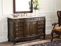 a bathroom vanity with a mirror above it and a chair in front of the sink