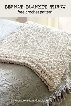 a crocheted blanket on top of a bed with text overlay that reads bernat blanket throw free crochet pattern