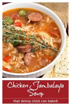 chicken jambala soup in a white bowl with crackers