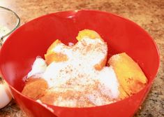 a red bowl filled with powdered sugar next to an egg on top of a counter