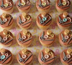 cupcakes decorated with sewing supplies on a table